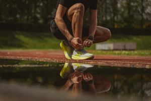 Runner Lacing Up with Achilles Tendon