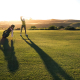 Golf player at top of backswing after physio for low back pain from golf.