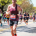 Close-up of a runner showing proper running form and cadence while going uphill.