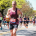 Close-up of a runner showing proper running form and cadence while going uphill.