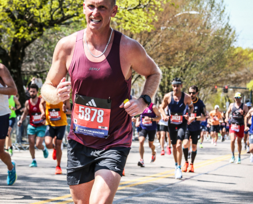 Close-up of a runner showing proper running form and cadence while going uphill.